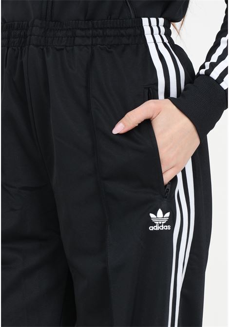 Firebird Loose black women's joggers with vertical stripes ADIDAS ORIGINALS | IT7404.